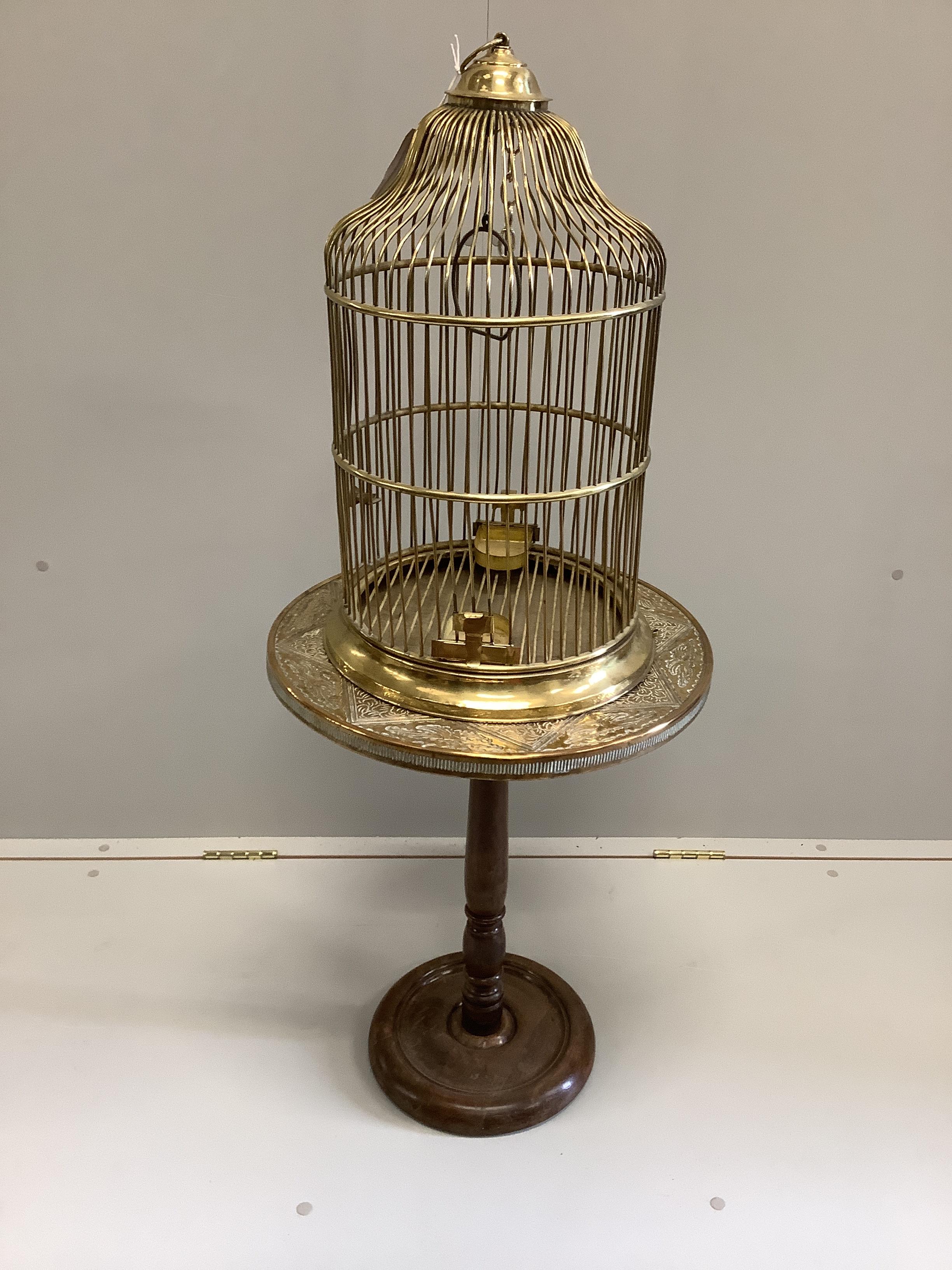 A brass birdcage on circular brass top occasional table, combined height 110cm